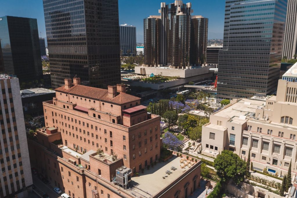 Stunning aerial photo of downtown Los Angeles showing skyscrapers and urban scenery on a sunny day.