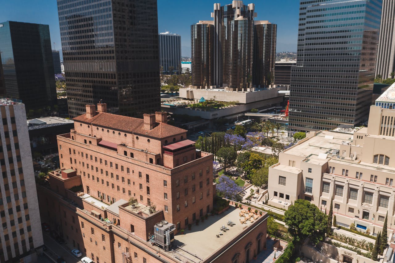 Stunning aerial photo of downtown Los Angeles showing skyscrapers and urban scenery on a sunny day.